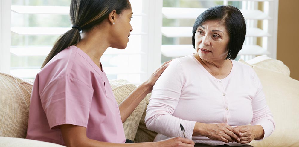 caregiver with elderly client talking