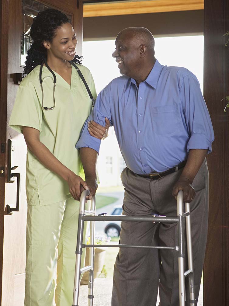 Caregiver helping Client in walking with walker