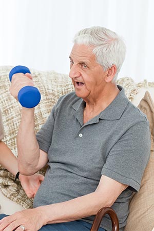 Elderly client doing strength excercise with dumpbell